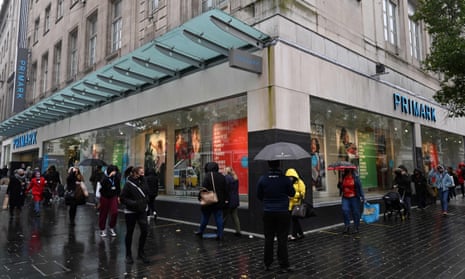 Shoppers queue to enter a Primark store in Liverpool on Wednesday.
