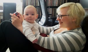 Keza plays video games with her baby son.