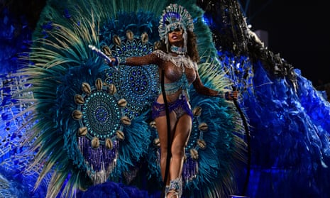 woman in a dress festooned with lots of feathers performs