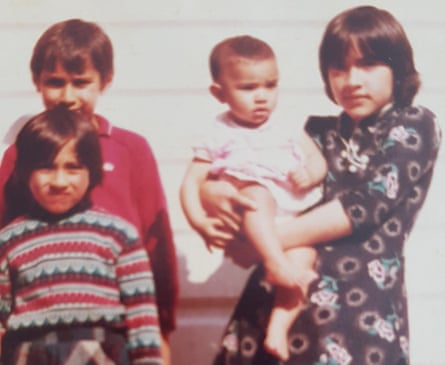 Saima Mir holding her sister Javaria, with brother Zafar and sister Fozia in 1984
