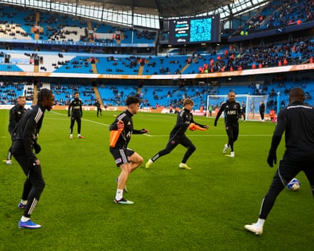 The Exeter players warm up on the Etihad pitch