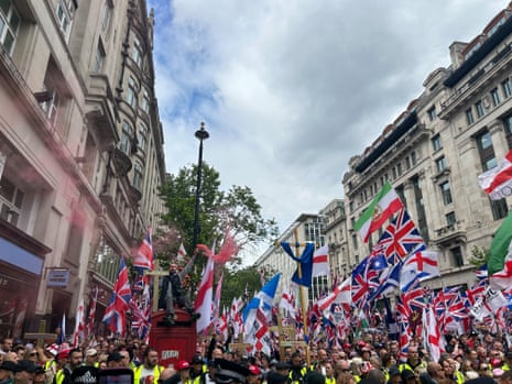 People take part in Tommy Robinson's Unite the Kingdom march in central London.
