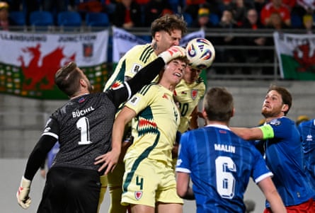 Liechtenstein’s goalkeeper Benjamin Buchel punches clear, beating Dylan Lawlor, Daniel James and Joe Rodon to the ball.