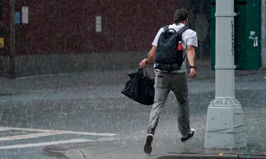 A man runs through the rain in the Chelsea area of New York on Thursday.