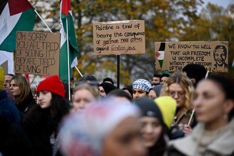 Demonstrators hold up placards with the lettering reading 'Oh sorry, you are tired of seeing it - they are tired of living it' (L), 'Palestine is tired of bearing the consequences of German Nazi crimes against 6 million Jews' (C), and others as they take part in a rally in solidarity with Palestinians at Oranienplatz Square in Berlin's Kreuzberg district, Germany, on November 11, 2023.