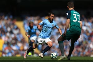 Bernardo Silva of Manchester City runs with the ball as Spurs’ Ben Davies looks on.
