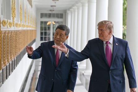 two men gesture to a wall