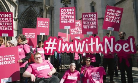 Campaigners from Dignity in Dying and supporters of Noel Conway, who has motor neurone disease, carry banners with slogans such as 'Give me choice over my death' and '#ImwithNoel'.