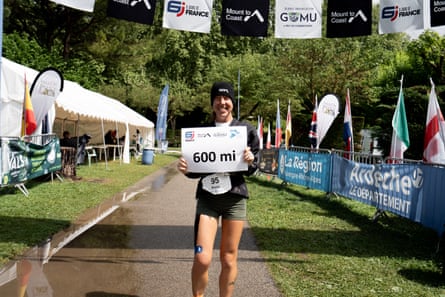 Megan Eckert holds up a 600-mile sign after her record-setting run last May.