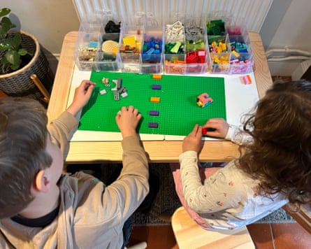 Two kids playing with Lego