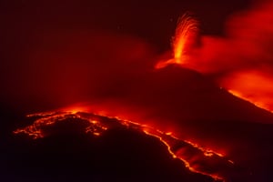 An erupting volcano and lava flows