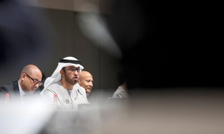 Sultan Al Jaber seen from a distance in sharp focus through an out-of-focus foreground