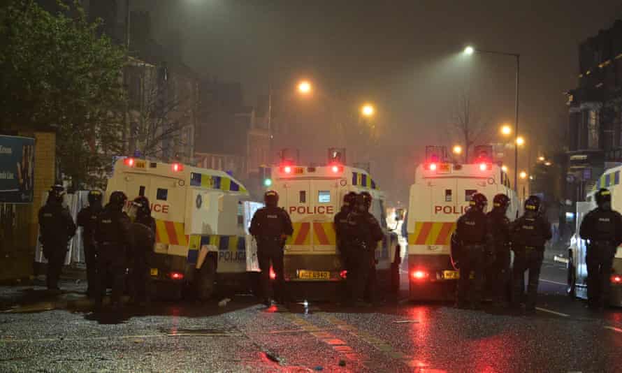 Riot police gather as clashes between youths continued at the Springfield Road/Lanark Way intersection in Belfast.
