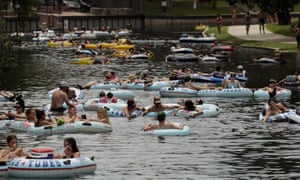 Tubers float in the Comal River despite the recent spike in Covid-19 cases Thursday, in New Braunfels, Texas.