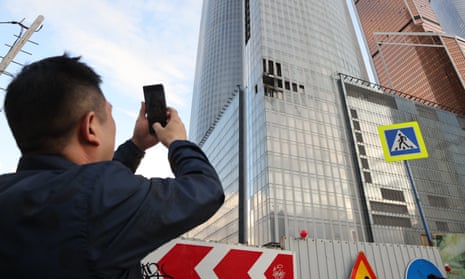 A man photographs a building damaged by a drone in the Moscow-City business centre on Wednesday