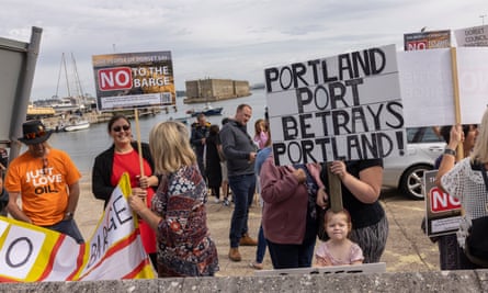 People demonstrate against the arrival of the Bibby Stockholm barge in Portland harbour, where it will house asylum seekers.