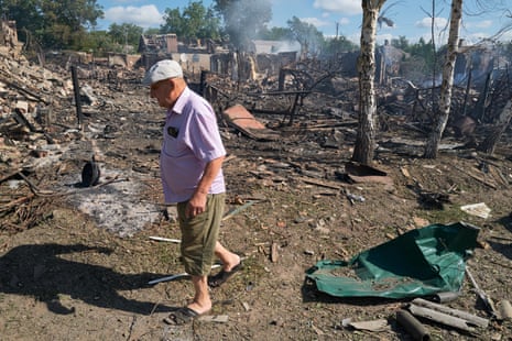 A resident walks through his neighbourhood in Sloviansk, attacked a day earlier by Russian forces.