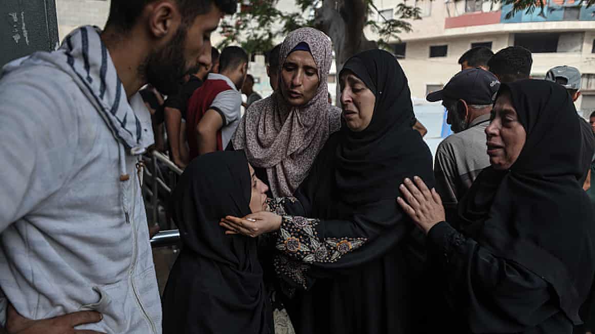 Mourning women support each other