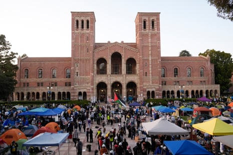 Demonstrators walk in an encampment on the UCLA campus.