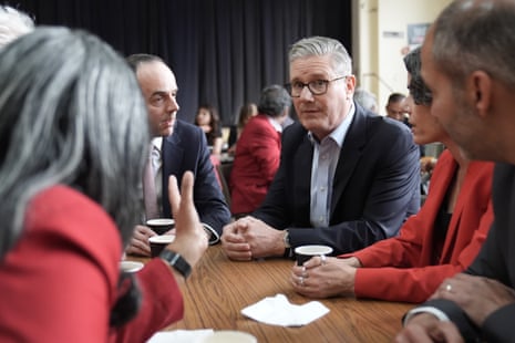 Keir Starmer and James Murray, chief secretary to the Treasury (left), with Labour party members at Kingsdown methodist church Hall in Ealing,.