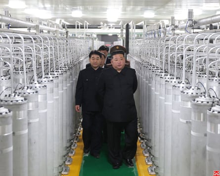 Kim walks among rows of metal cylinders