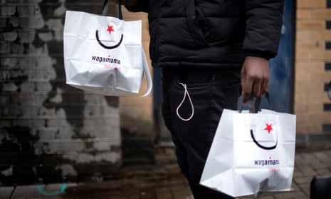 Wagamama takeaway bags being collected from Wagamama’s Hackney delivery kitchen in East London.