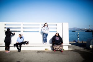 Dee Dee Castro (second from left) dries her feet after she rode in a traditional tribal canoe around Alcatraz, with Violet McCloud, 16, (second from right) and her mother Joy Pena.