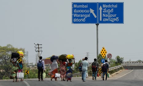 Migrant workers from the Indian state of Maharashtra walk along a highway to reach their home towns during a government-imposed nationwide lockdown as a preventive measure against the Covid-19 outbreak.