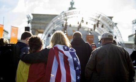 Women carrying German and US flags wait for Obama and Merkel to appear.