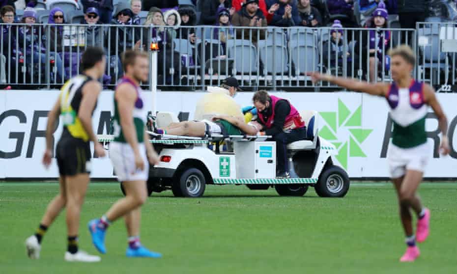File photo of a player being assisted off the field during a 2021 AFL match between the Fremantle Dockers and the Richmond Tigers