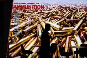 A visitor walks past a display showing the range of ammunition