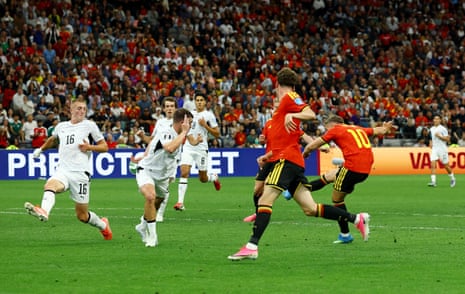 Leandro Trossard shoots before the ball hits the arm of New Zealand's Finn Surman.