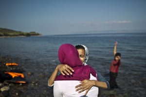 Afghan women embrace each other after arriving in Greece