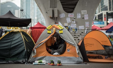A pro-democracy protester uses her phone in her tent at the Occupy movement’s main protest site in Hong Kong, December 2014.