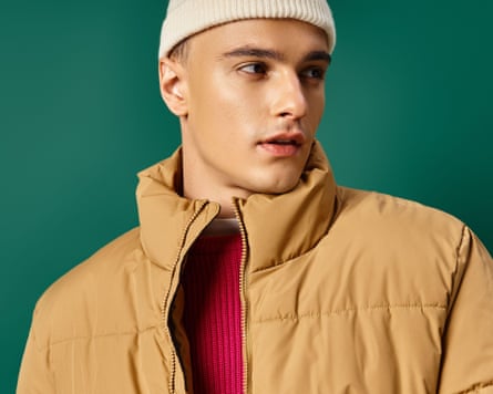 A man wearing a puffer and a beanie
