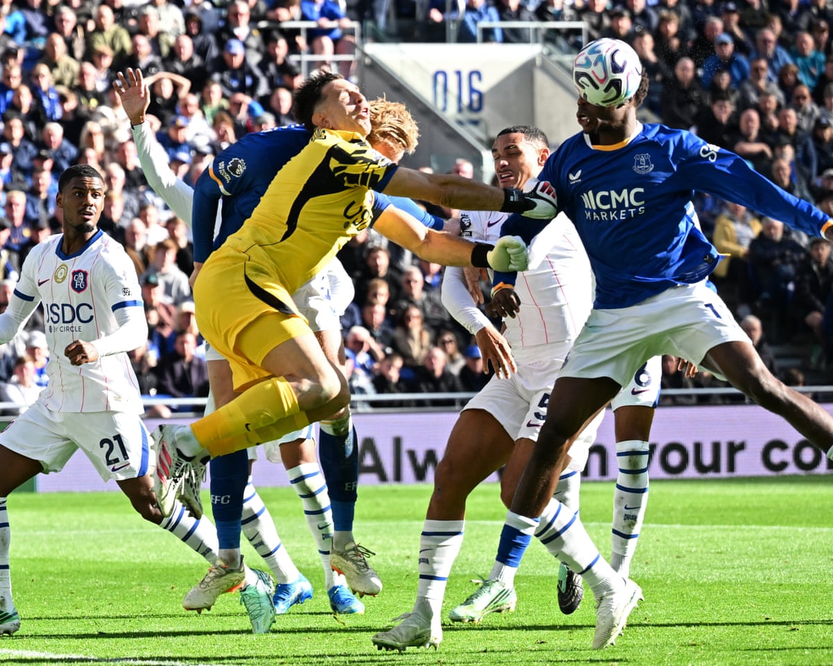 Chelsea goalkeeper Emiliano Martinez challenges Everton defender Jarrad Branthwaite