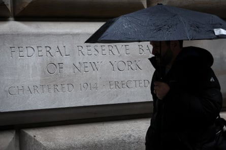man passes in front of federal reserve building
