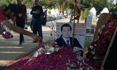 People visit the Islamabad grave of Arshad Sharif, who was killed in Kenya.