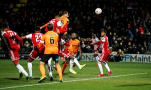 Daniel Sweeney from Barnett hit a header that is well-rescued by Luc Daniels.