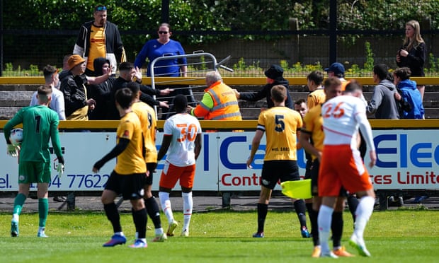 The referee was forced to take players off the pitch after clashes between Blackpool and Southport supporters at Haig Avenue.