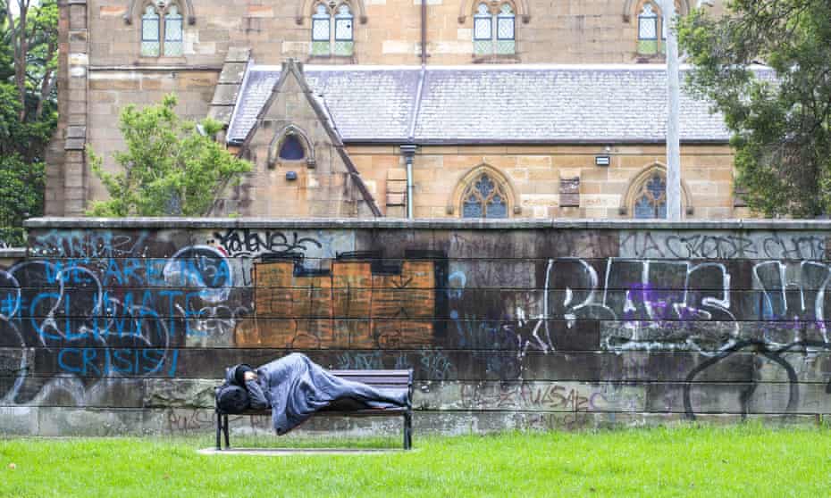 A homeless man sleeps on a park bench in Sydney in March. In response to coronavirus, state governments arranged for thousands of rough sleepers to access emergency accommodation.