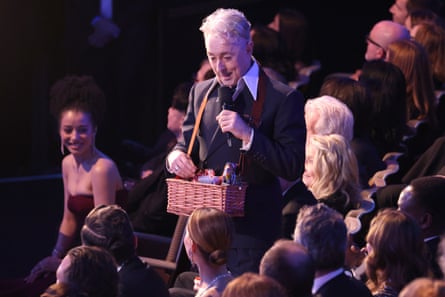 Snack time … Cumming distributes crisps and biscuits.