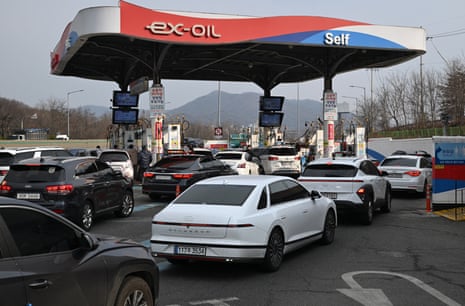 Motorists queueto fill up at a petrol station in Seoul after a surge in the price of oil