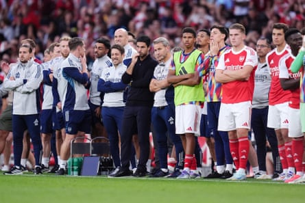 Mikel Arteta (centre, in black) watches the penalty shootout against Villarreal