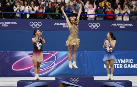 Gold medalist Alysa Liu celebrates alongside silver medalist Kaori Sakamoto and bronze medalist Ami Nakai of Japan.