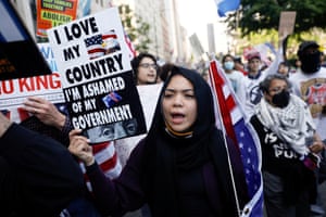 a person holds a sign that reads ‘I love my country I’m ashamed of my government’