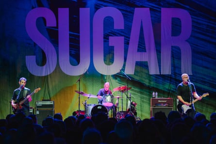 Sugar performing against a backdrop of their name