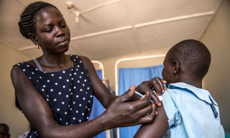 Evelyn Ayo, a vaccinator at the Reproductive Health Uganda clinic in Gulu, administers an HPV vaccine