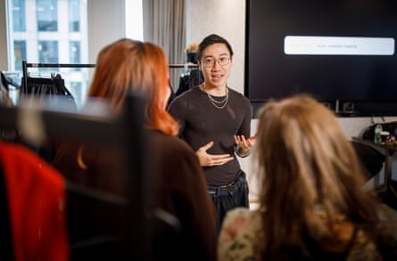 Designer Chet Lo shows the fabrics and explains the garments to guests in a touch tour.