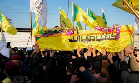Fighters from the Popular Mobilization Forces, carry the coffin of a commander from the Kataib Hezbollah paramilitary group, Abu Bakr al-Saadi, who was killed in a US airstrike